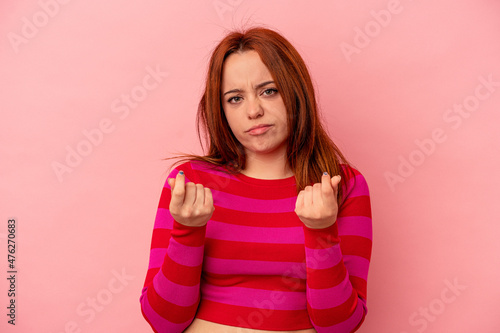 Young caucasian woman isolated on pink background showing that she has no money.