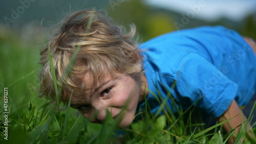 Little boy outside on grass portrait face