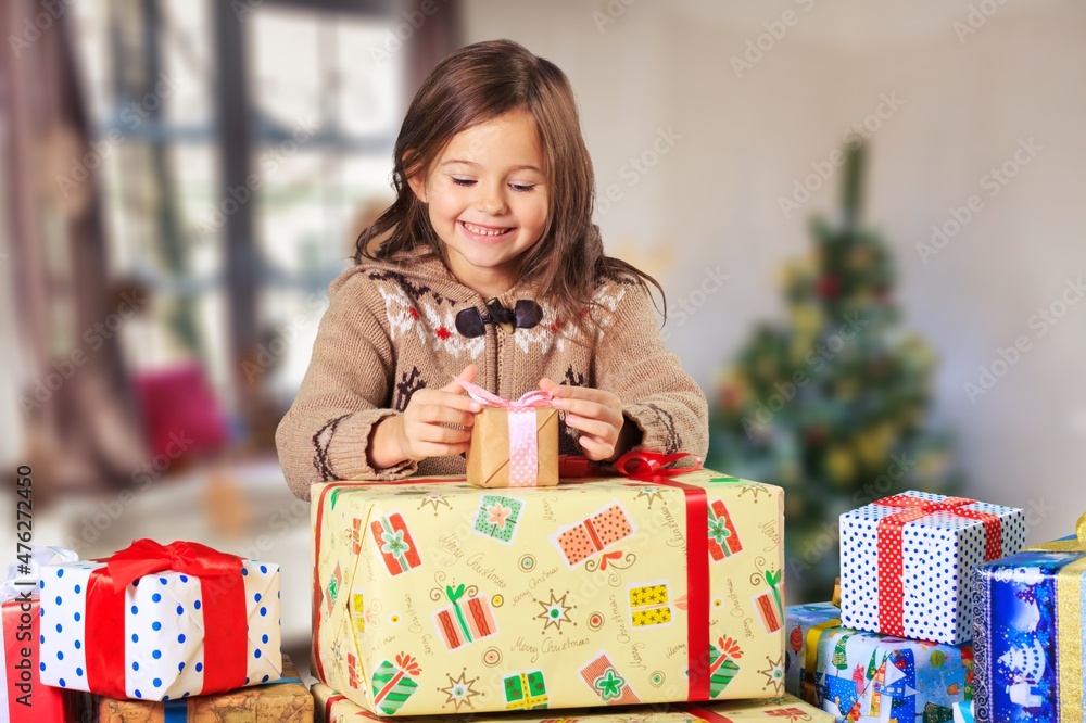 Easy to buy with online shopping! Satisfied girl holding Christmas present, Easy to buy with online shopping! Satisfied girl holding Christmas present,