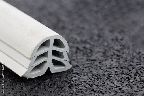 close-up of grey color rubber dilatation on profile, black background