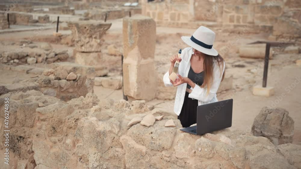 Archaeological Digging Site Discivery: Beautiful Female Archaeologist Doing Research, Using Laptop, Analysing Unearthed Ancient Civilization Culture Artifacts. Great Historian on Excavation Site. Archaeological Digging Site Discivery: Beautiful Female Archaeologist Doing Research, Using Laptop, Analysing Unearthed Ancient Civilization Culture Artifacts. Great Historian on Excavation Site.