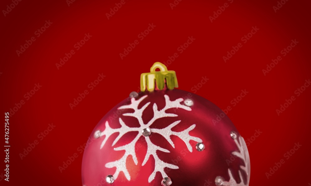 Beautiful Christmas ball against a colored background. Christmas decoration, festive atmosphere concept.