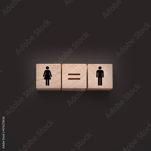 Concepts of gender equality. wooden cubes with female and male symbol and equal sign. Equal pay social quaranty concept photo