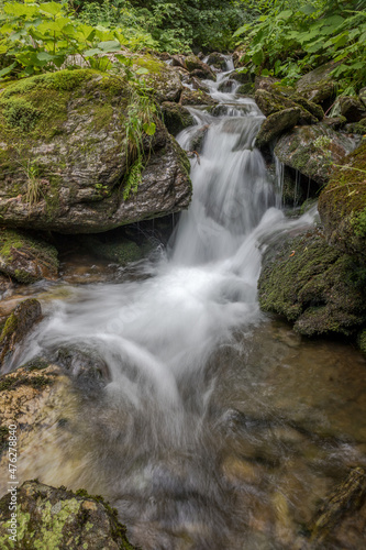 waterfall and flowing water in a mountain stream