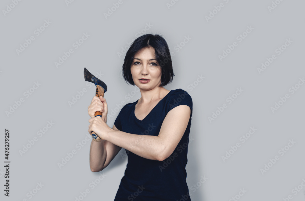 Ax in hands of woman. Short black hair. Concept of violence. Ax in hands of woman. Short black hair. Concept of violence.