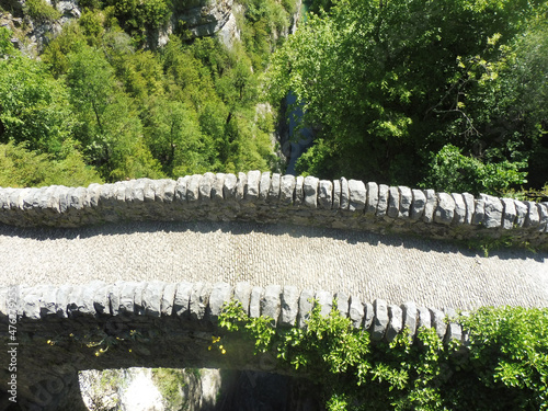 Top view of an empty old stone bridge of San Urbez over the river in nature on a sunny day photo