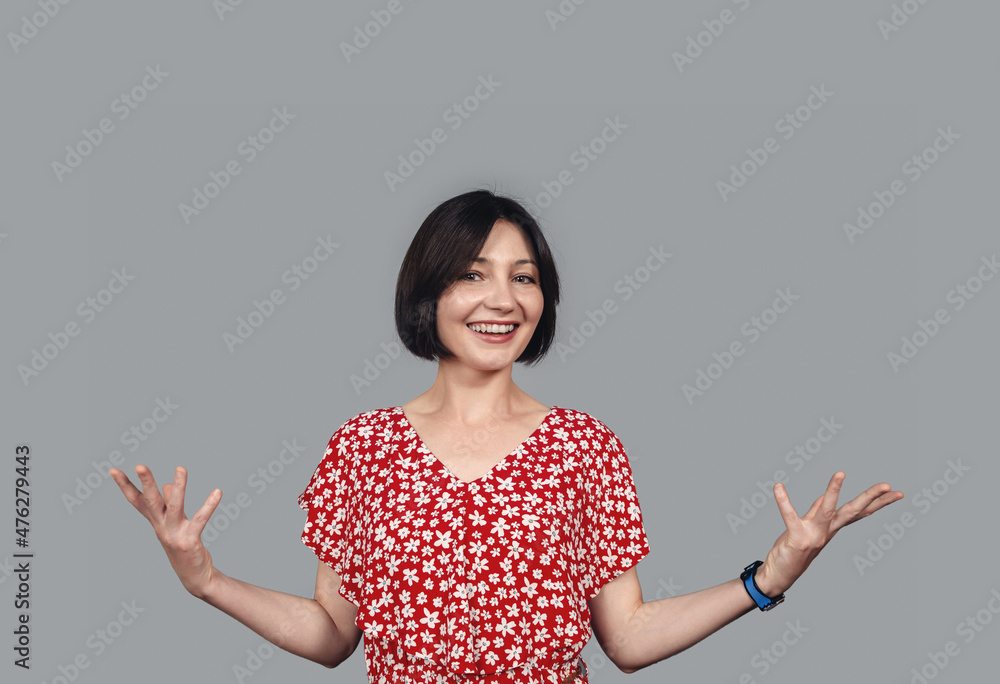 Dark-haired optimistic woman raises her hands in joy and surprise. Happy in anticipation of the surprise.. Dark-haired optimistic woman raises her hands in joy and surprise. Happy in anticipation of the surprise..