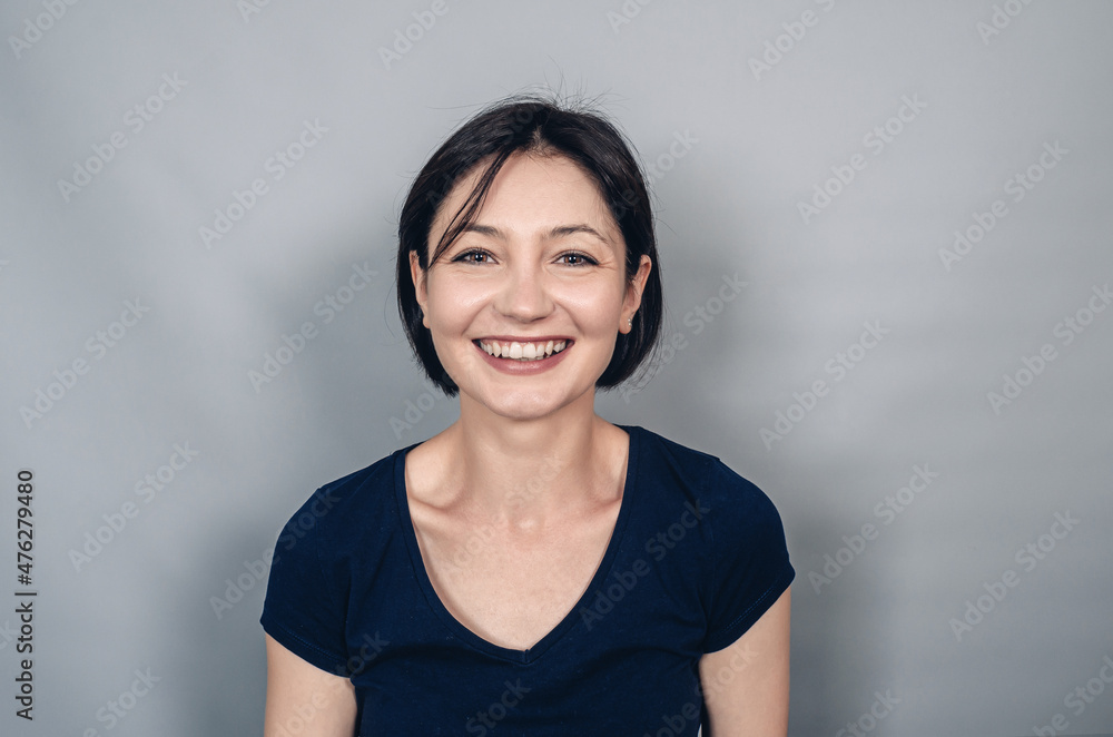 Joyful beautiful woman with black short hair. Close-up. Emotions of joy of happiness. Snow-white smile. Joyful beautiful woman with black short hair. Close-up. Emotions of joy of happiness. Snow-white smile.