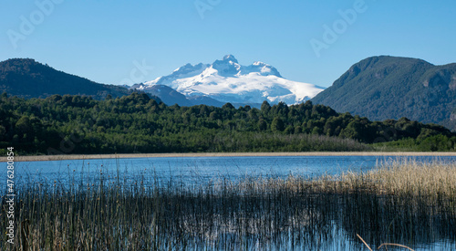 A beautiful mountain with snow. Landscapes view with water, quit lake, mountains, tree, green