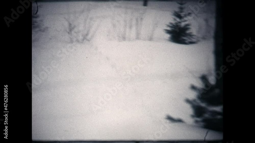 Pushing the Snow Blower 1972 - A boy pushes a snow blower as he clears snow from his driveway in Vernon Township, New Jersey in 1972.  photo