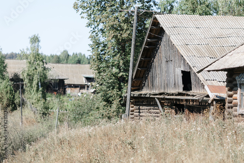 Russian village in summer. view of a wooden house. summer day, greenery and trees.