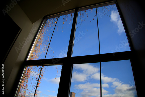 blue sky and clouds through a window of a building