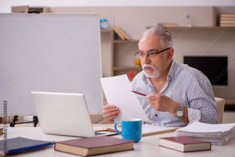 Old male employee working from home during pandemic Old male employee working from home during pandemic