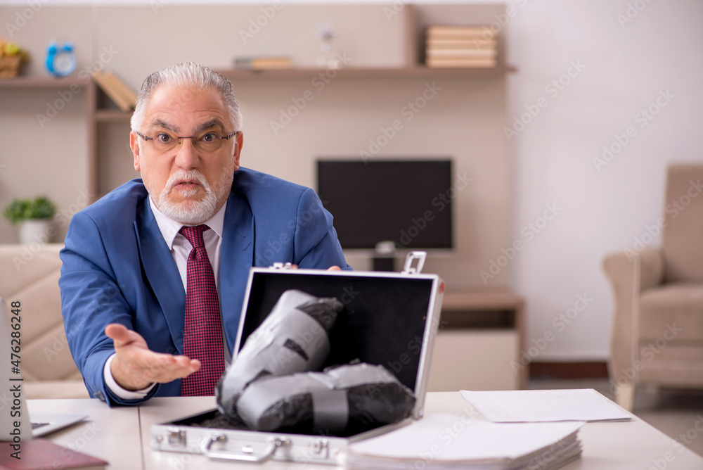 Old male employee in remuneration concept at home Old male employee in remuneration concept at home