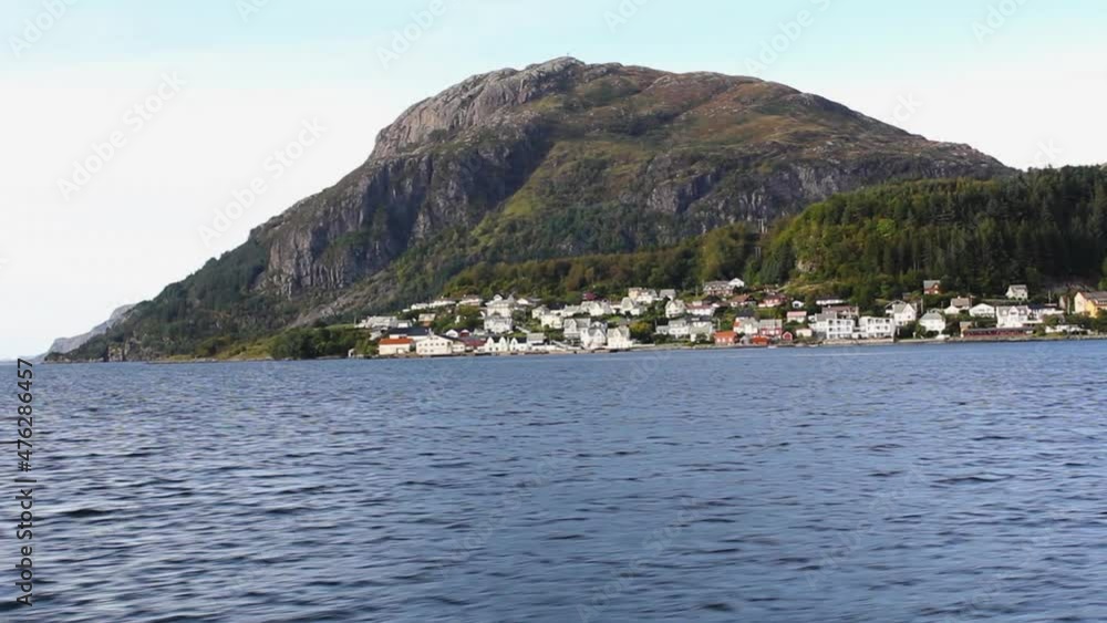 Traveling by boat through a typical Norwegian village Traveling by boat through a typical Norwegian village