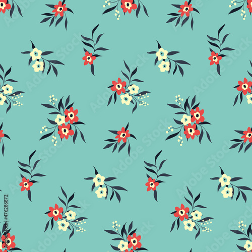 Seamless pattern with small floral bouquets on a blue background. Cute floral print with small red, white flowers, leaves. Botanical background design in winter colors. Vector.