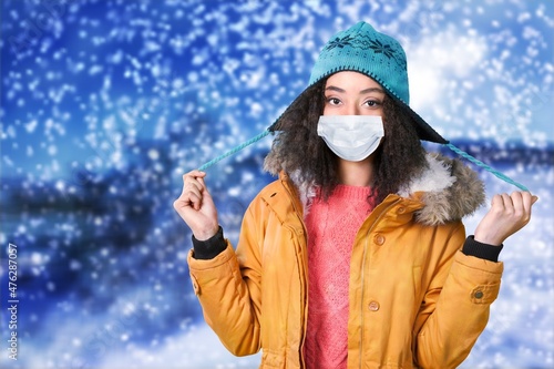 Christmas Woman in medical protective face mask, winter portrait