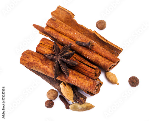 Cinnamon sticks and spieces close up on wooden table. Dark style photo