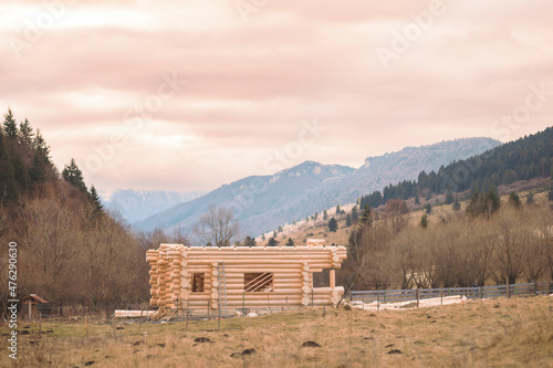 Wood cabin or mountain chalet house. Log home lumber construction. Lumber price surge because huge demand for lumber, due to a shortage of wood, timber prices have soared rising cost of new homes