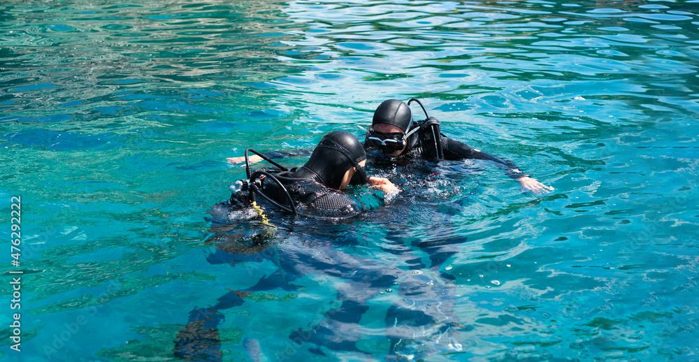 Initial immersion with an instructor underwater, breathing training under water. First time scuba dive. Diving lessons. Copy space.