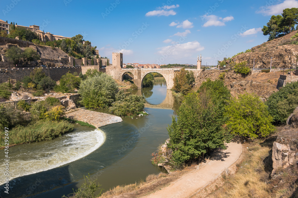 Toledo, Spain, October 2019 - View of Alcantara Bridge and it's reflection in the waters of Tejo River