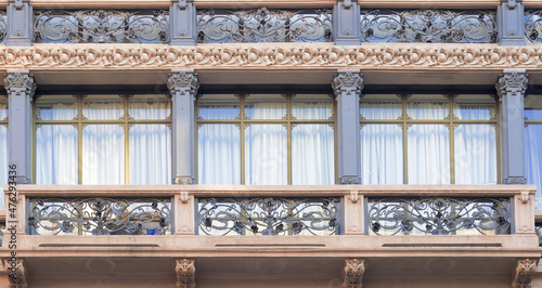 wrought iron decorations, art deco building facade in Milan, Italy.
