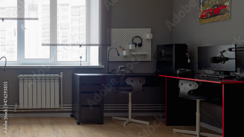 The interior of a teenage boy's room in dark gray and black colors