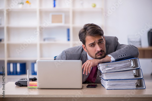 Young male employee working in the office