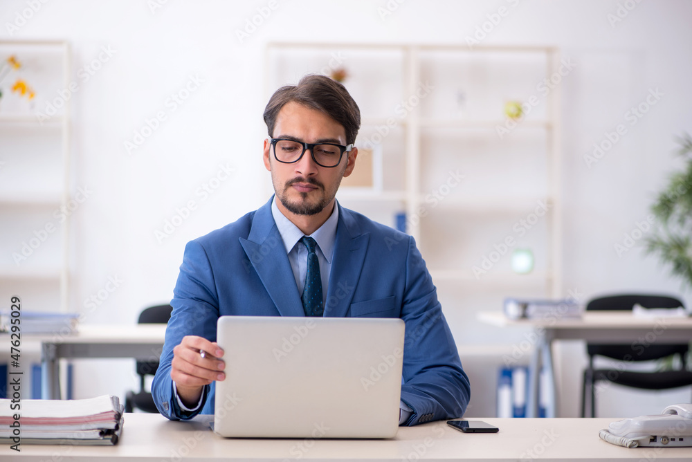 Young male employee working in the office Young male employee working in the office
