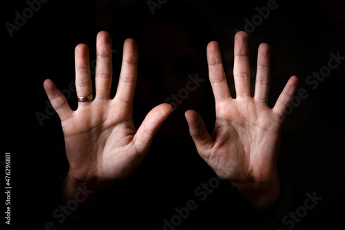 female palms aimed at the camera on a black background.