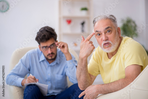 Old man visiting young male psychotherapist © Elnur