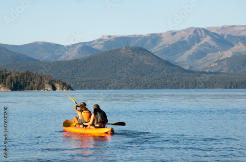 Two women rowing in kayak in the lake © Romina