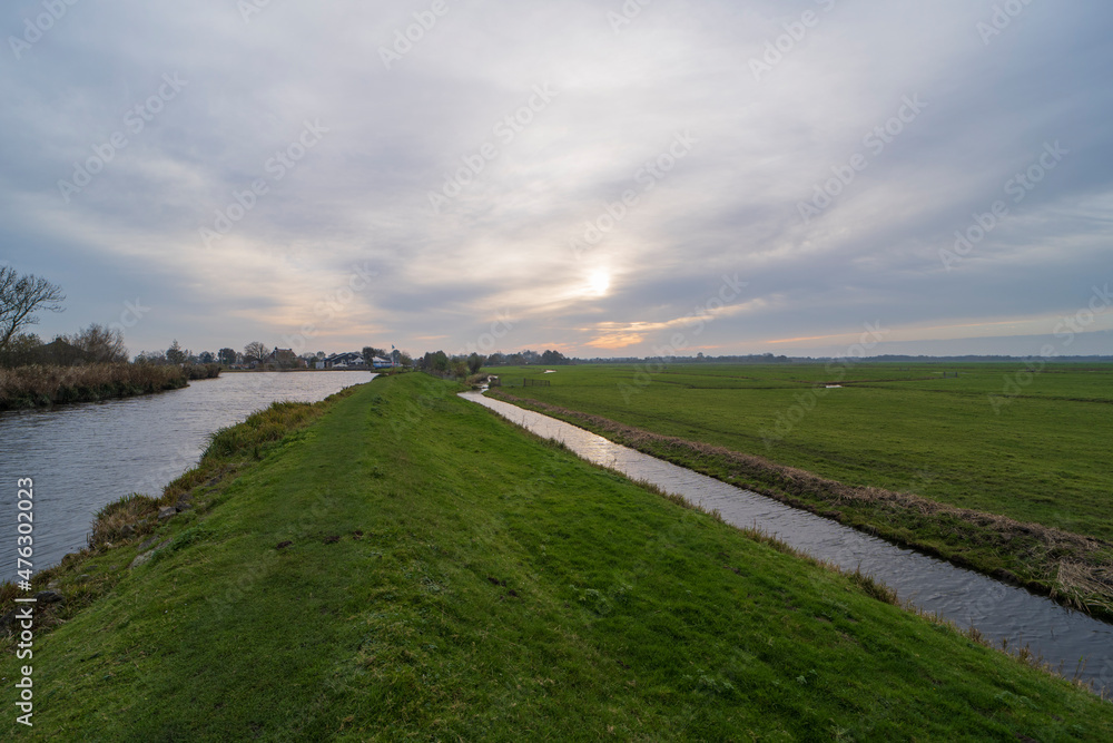 Fototapeta premium Autumn landscape photo of the Winkel river, The Netherlands 