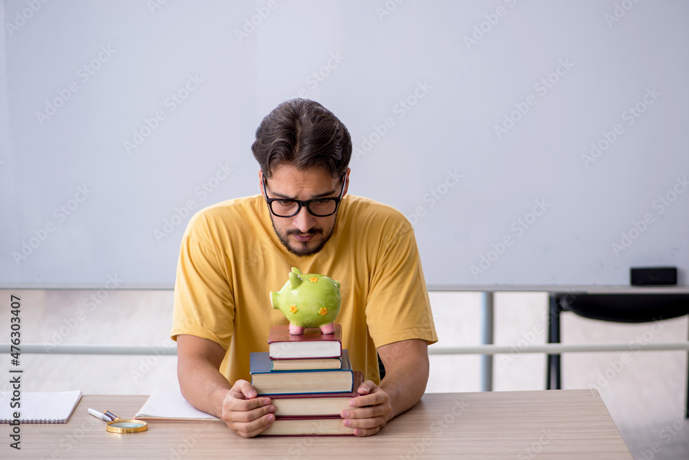 Young male student in expensive education concept Young male student in expensive education concept