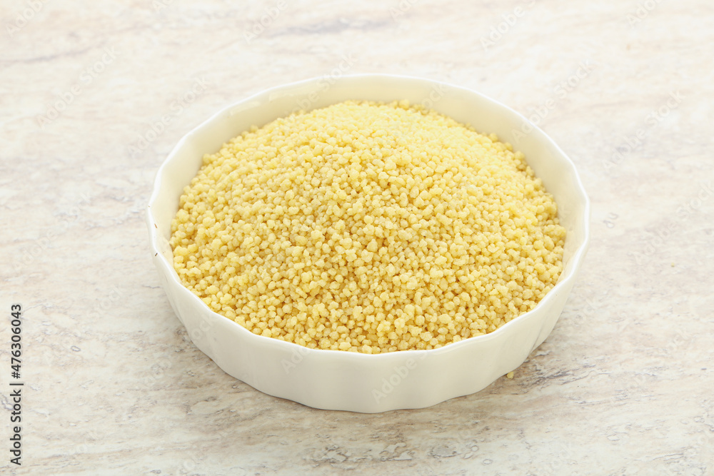 Raw couscous in the bowl Raw couscous in the bowl
