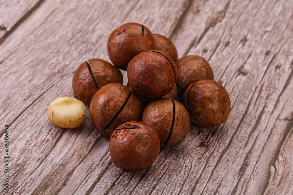 Obraz premium Brown macadamia nut heap over background