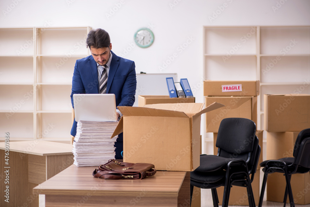 Young male employee in relocation concept Young male employee in relocation concept