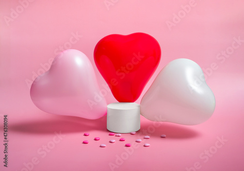Fototapeta Naklejka Na Ścianę i Meble -  Podium with heart shaped balloons on a pink background. Valentine's day holiday