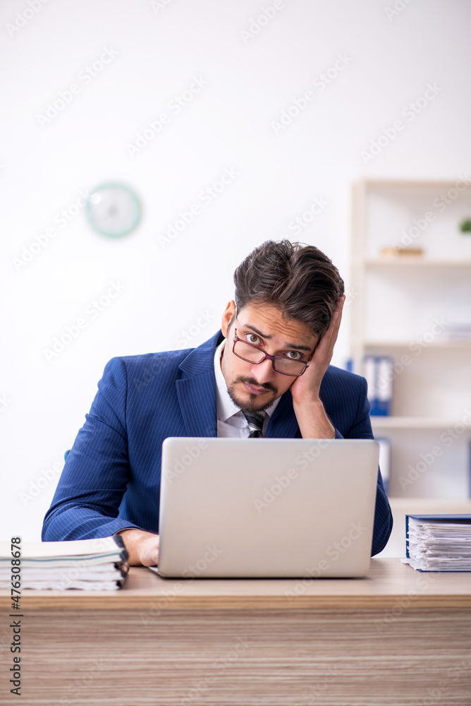 Young male employee working in the office Young male employee working in the office