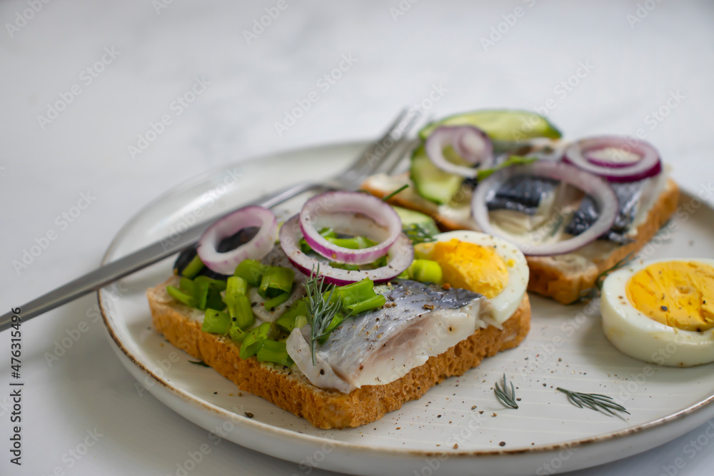 herring sandwich blue onion on wooden background herring sandwich blue onion on wooden background