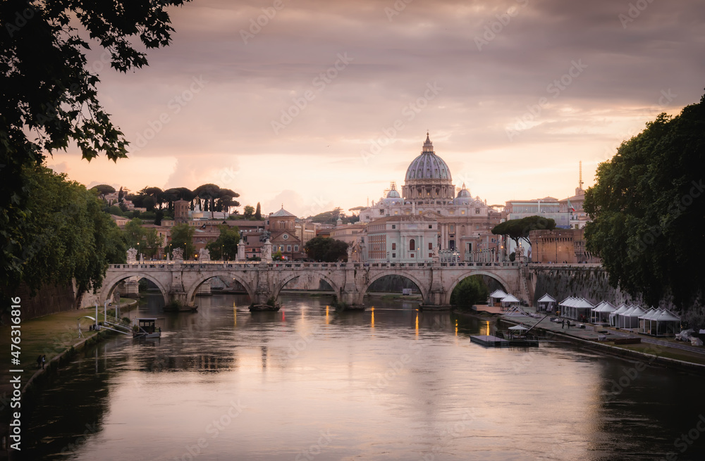 Postcard View of St Angelo Bridge with Vatican and St Peters Basilica under Sunset Sky in Rome, Italy