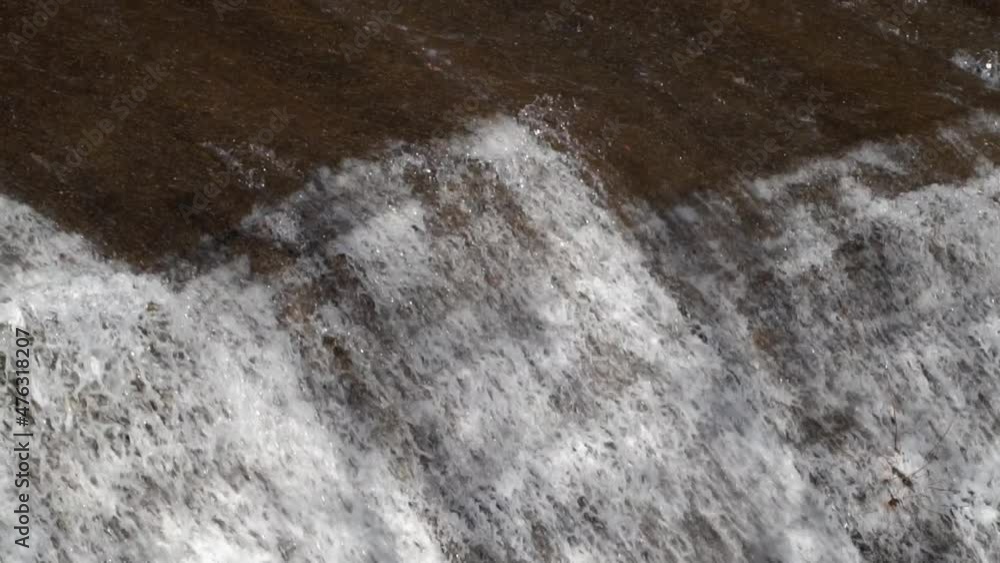 Waterfall water Cascading down the rock in slow motion Waterfall water Cascading down the rock in slow motion