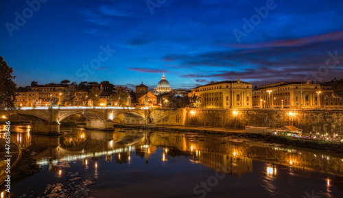 Sunset view at St. Peter's cathedral in Rome with its reflection on Tiber river