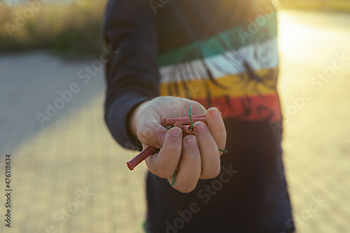 boy showing his hand full of firecrackers in valencian fallas festivals at the sunset photo