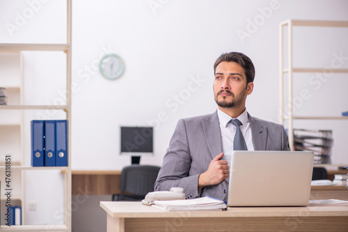 Young male employee working in the office