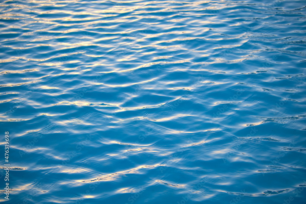 Closeup seascape surface of blue sea water with small ripple waves Closeup seascape surface of blue sea water with small ripple waves