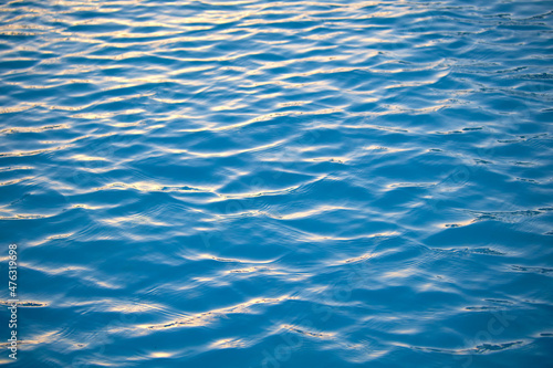 Closeup seascape surface of blue sea water with small ripple waves