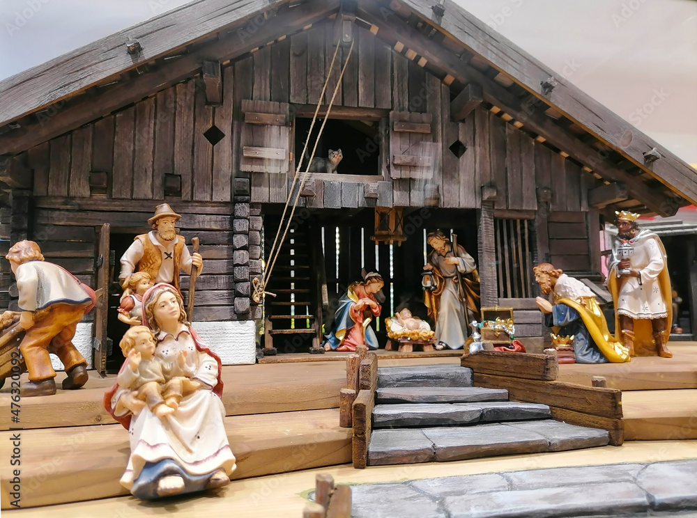 Traditional Christmas nativity scene with beautiful figures made out of wood. The birth of Jesus Christ in the manger surrounded by Joseph, Mary and the Magi.