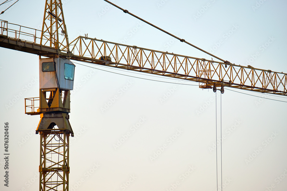 Tower crane at high residential apartment buildings construction site. Real estate development Tower crane at high residential apartment buildings construction site. Real estate development