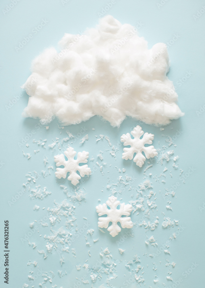 Snowflakes fall from the cloud. Winter New Year handmade concept. Flat lay background. Snowflakes fall from the cloud. Winter New Year handmade concept. Flat lay background.
